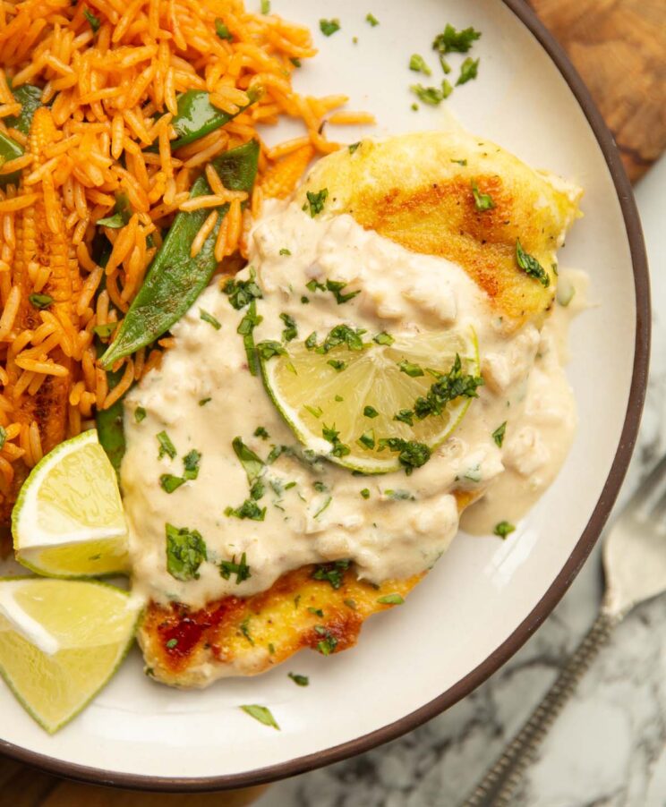 coconut lime chicken coconut lime chicken served on small white plate with lime, coriander and rice