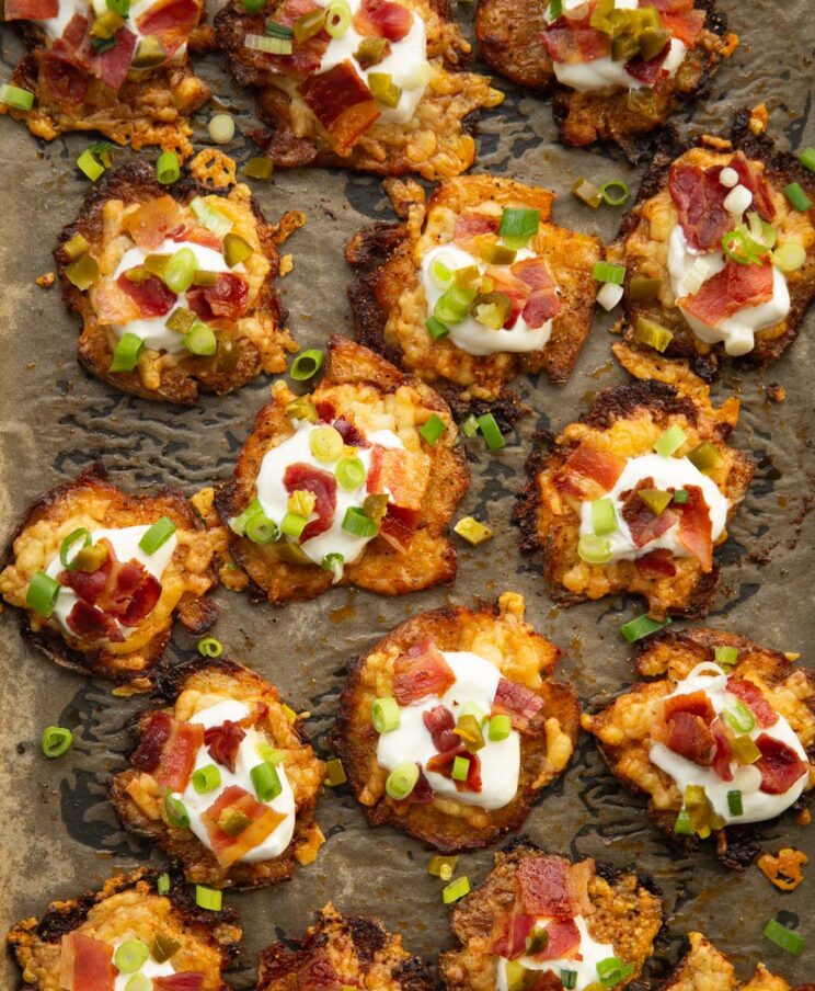 loaded smashed potatoes overhead shot of loaded smashed potatoes on baking tray